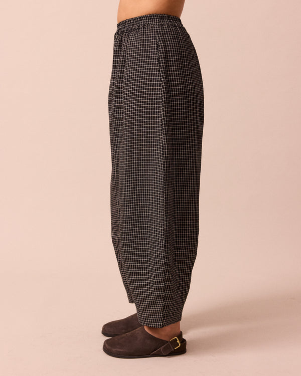 model wears daisy black mini grid linen trousers left