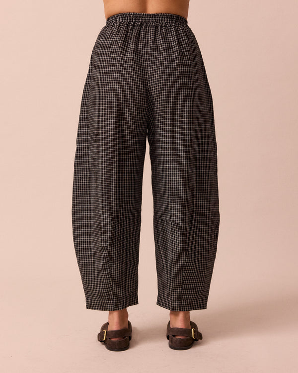 model wears daisy black mini grid linen trousers back