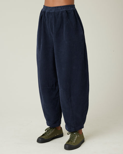 model wears navy cord daisy trousers left