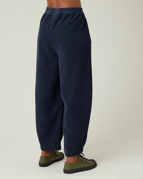 model wears navy cord daisy trousers right