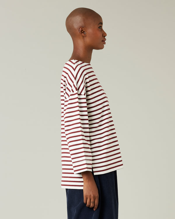 model wears cherry and ecru breton top