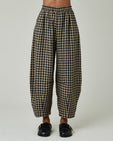 model wears coffee gingham daisy trousers front