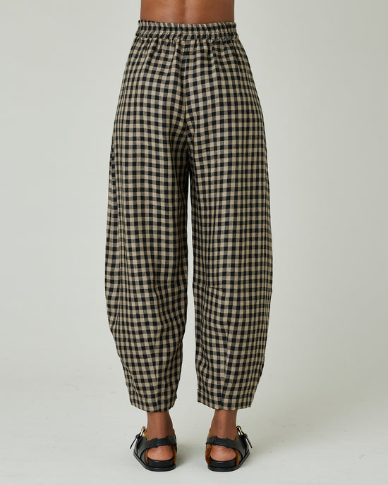 model wears coffee gingham daisy trousers back