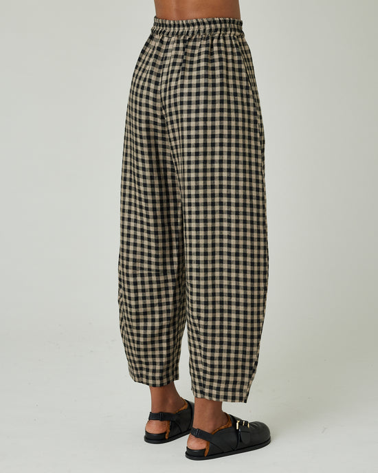 model wears coffee gingham daisy trousers right