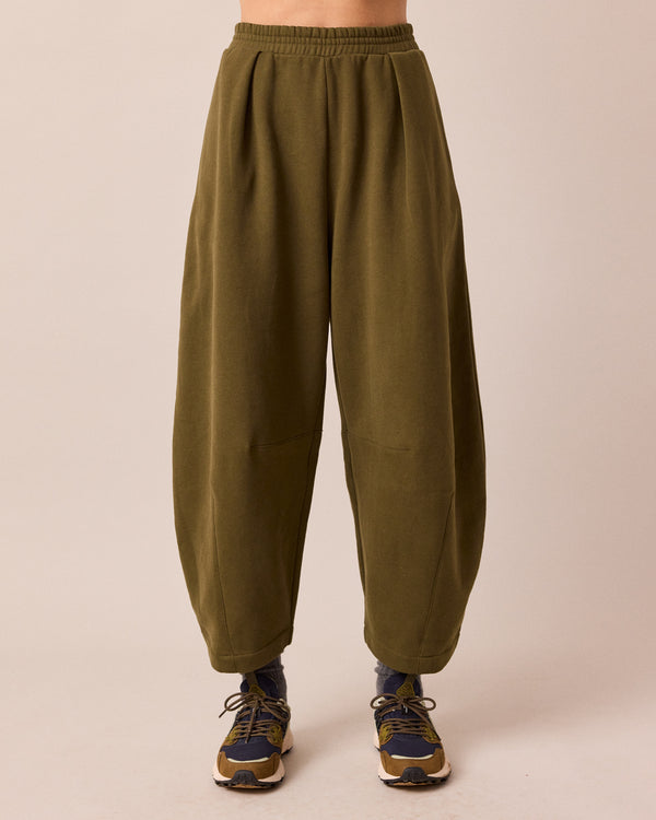 model wears daisy earth green jersey trousers front