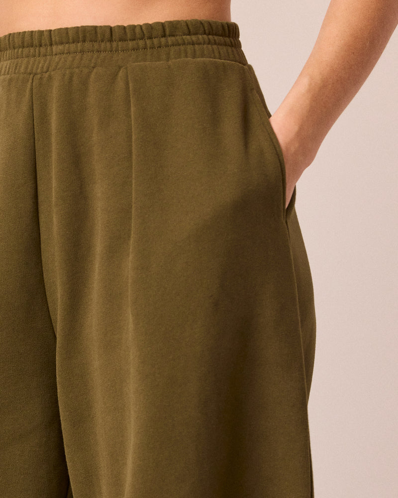 model wears daisy earth green jersey trousers