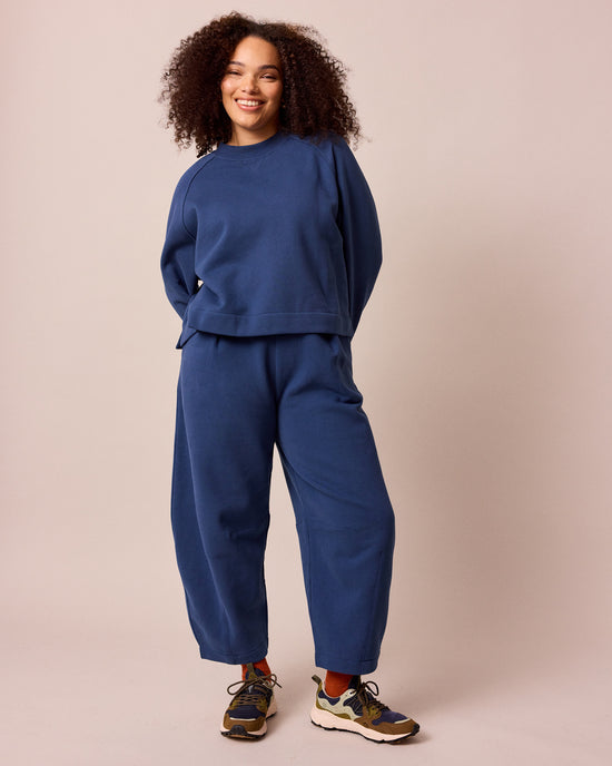 model wears french navy daisy fleeceback jersey trousers right