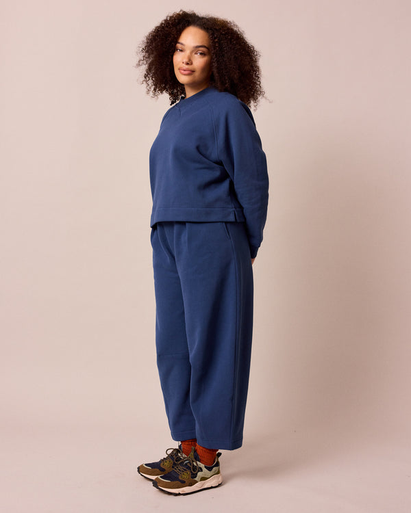 model wears french navy daisy fleeceback jersey trousers left