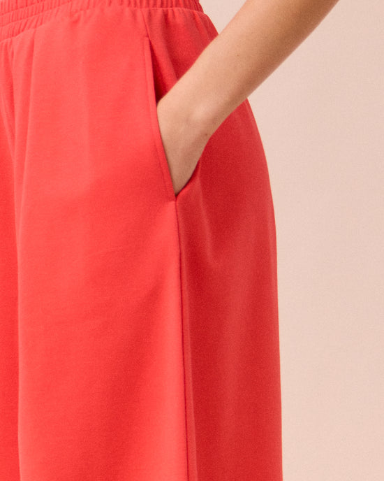 model wears daisy watermelon jersey trousers