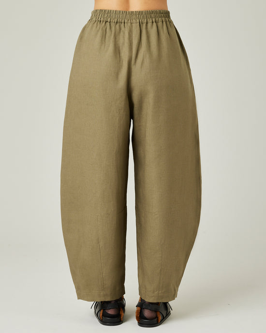 model wears light khaki linen daisy trousers back