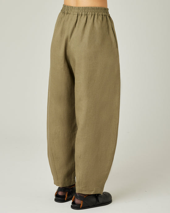 model wears light khaki linen daisy trousers right