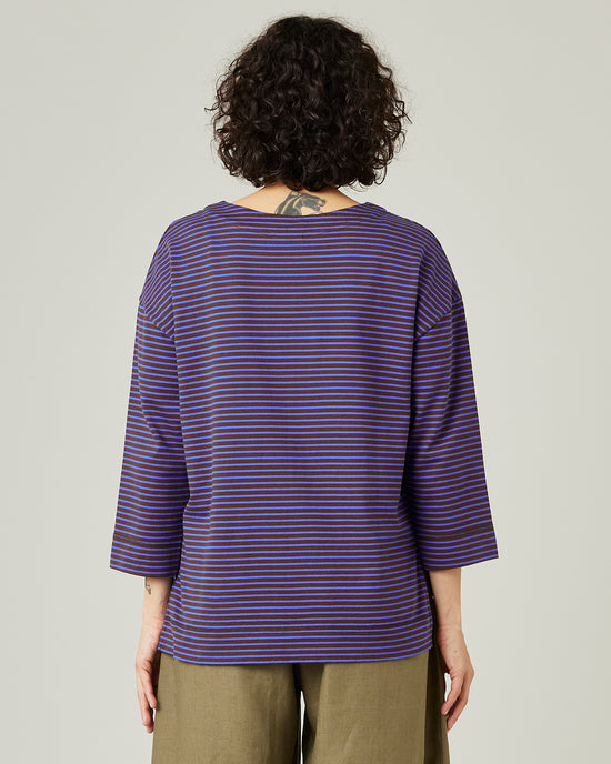 model wears blue and brown stripe breton top 