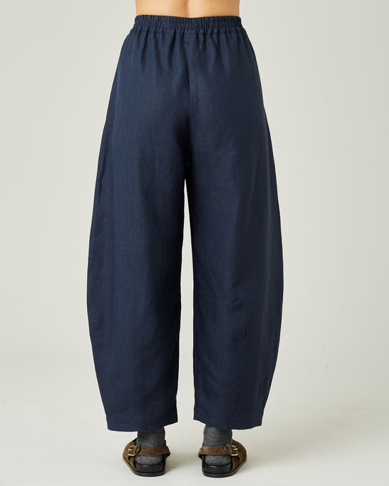 model wears navy linen daisy trousers back