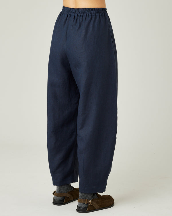 model wears navy linen daisy trousers right