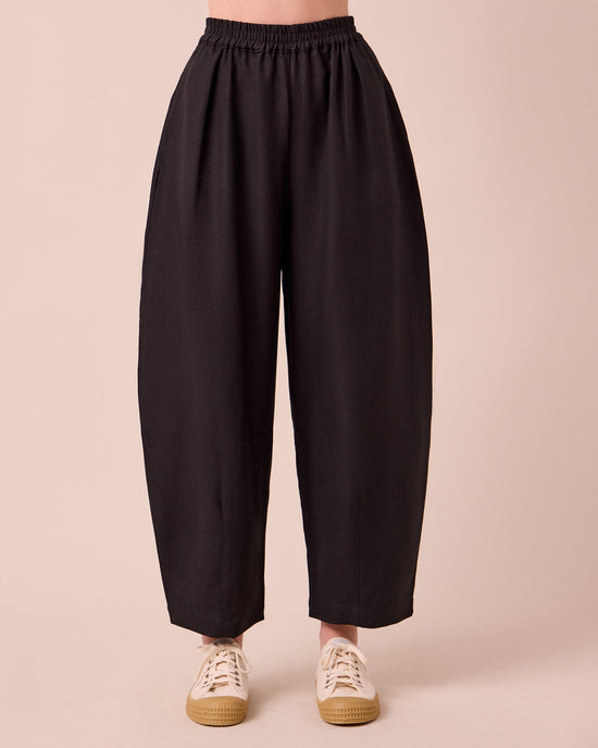 model wears daisy black linen trousers front