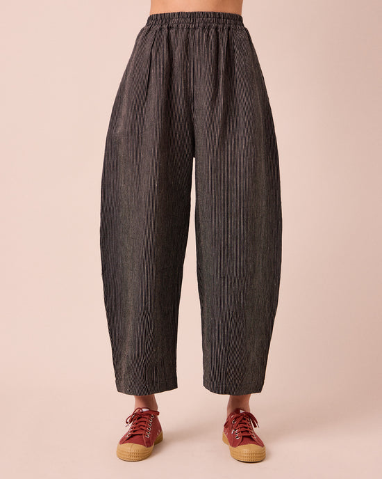 model wears daisy black and ecru pencil stripe linen trousers front