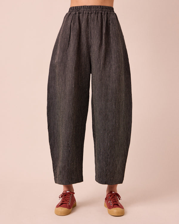 model wears daisy black and ecru pencil stripe linen trousers front
