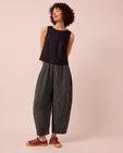 model wears daisy black and ecru pencil stripe linen trousers left