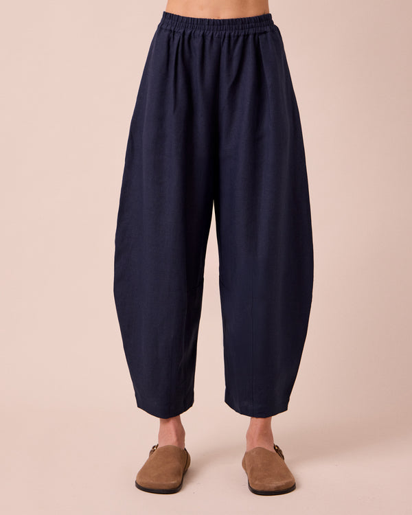 model wears daisy navy linen trousers front