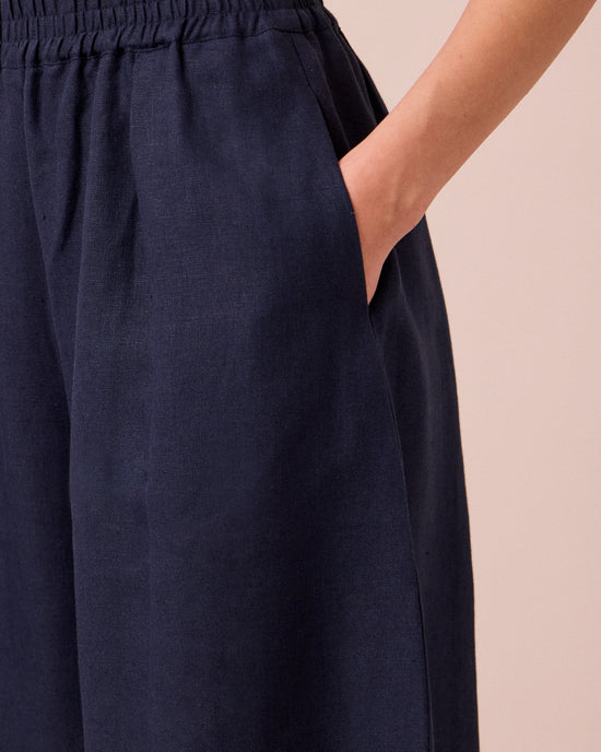 model wears daisy navy linen trousers 