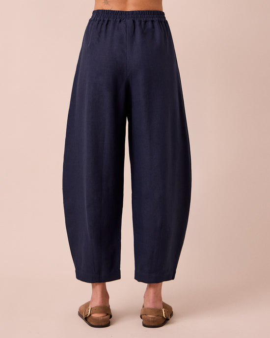model wears daisy navy linen trousers back
