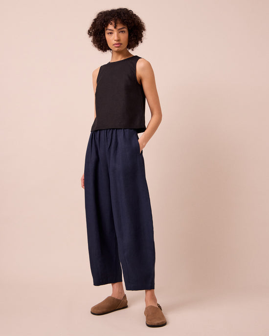 model wears daisy navy linen trousers right