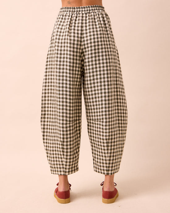 model wears daisy olive gingham linen trousers back