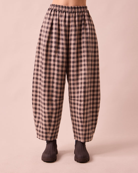 model wears daisy stone gingham linen trousers front