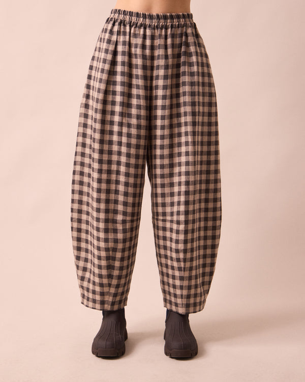 model wears daisy stone gingham linen trousers front