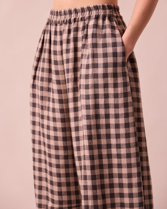 model wears daisy stone gingham linen trousers
