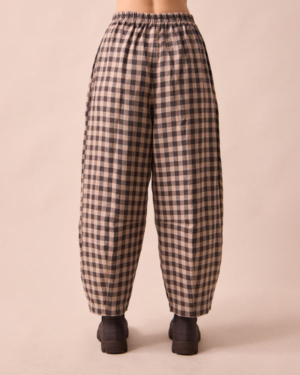 model wears daisy stone gingham linen trousers back