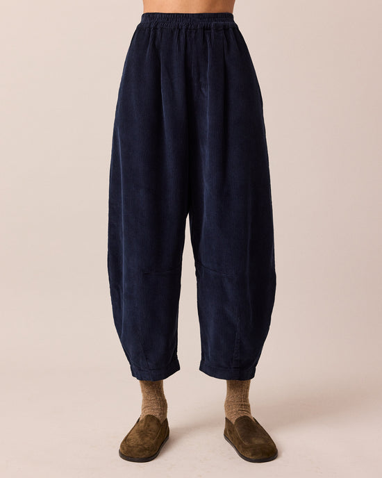 model wears daisy navy cord trousers front