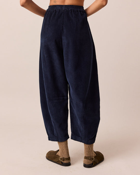 model wears daisy navy cord trousers back