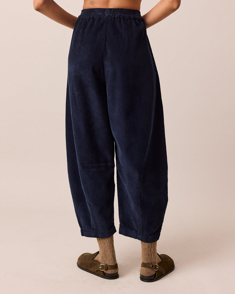 model wears daisy navy cord trousers back
