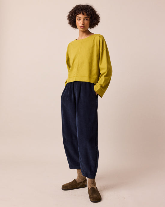 model wears daisy navy cord trousers left