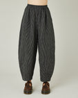 model wears black and ecru pencil stripe daisy trousers front