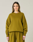 pregnant model wears olive green jersey riley jumper