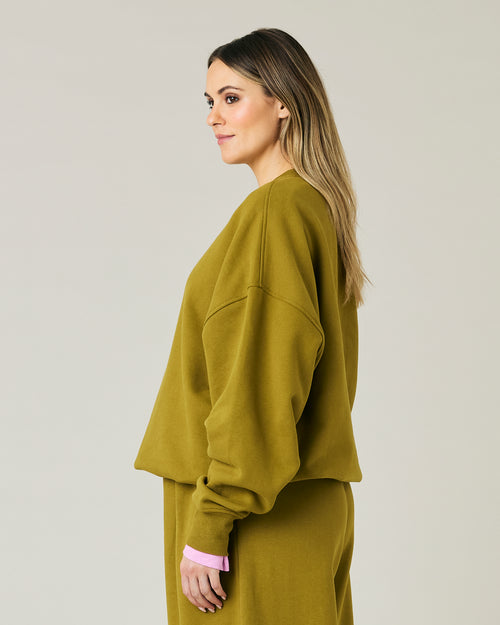 pregnant model wears olive green jersey riley jumper