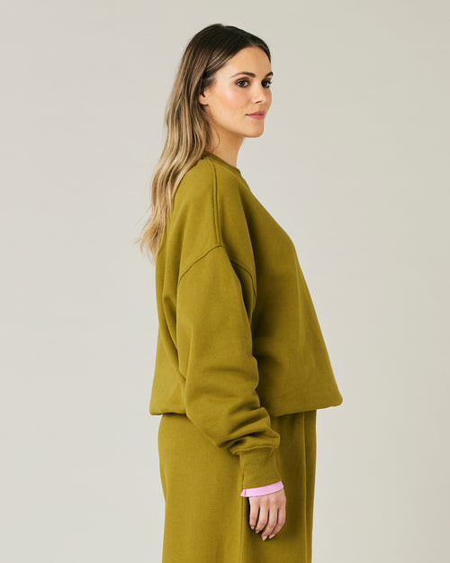 pregnant model wears olive green jersey riley jumper