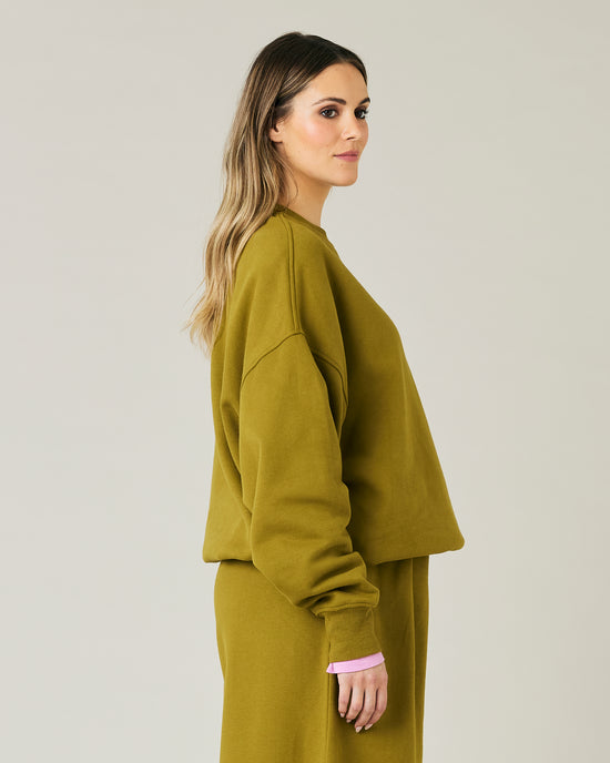 pregnant model wears olive green jersey riley jumper