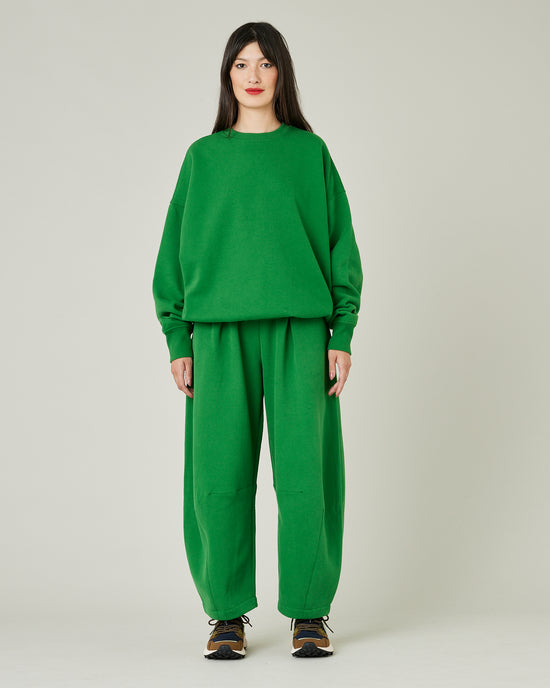 model wears juniper green daisy jersey trousers