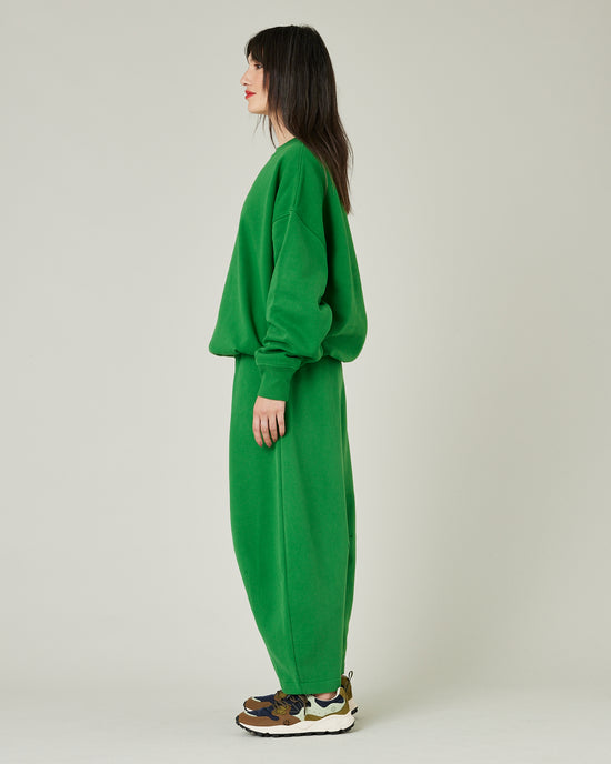 model wears juniper green daisy jersey trousers