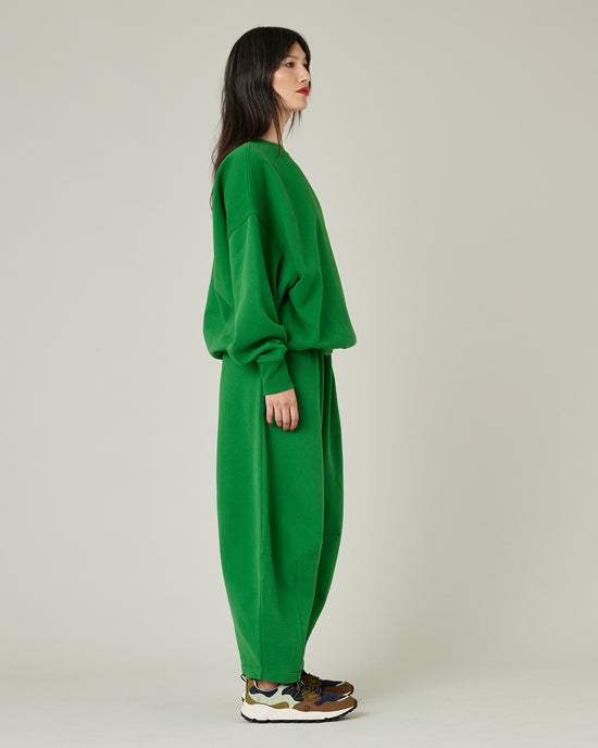 model wears juniper green daisy jersey trousers