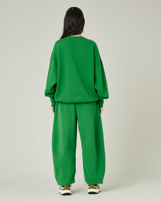 model wears juniper green daisy jersey trousers