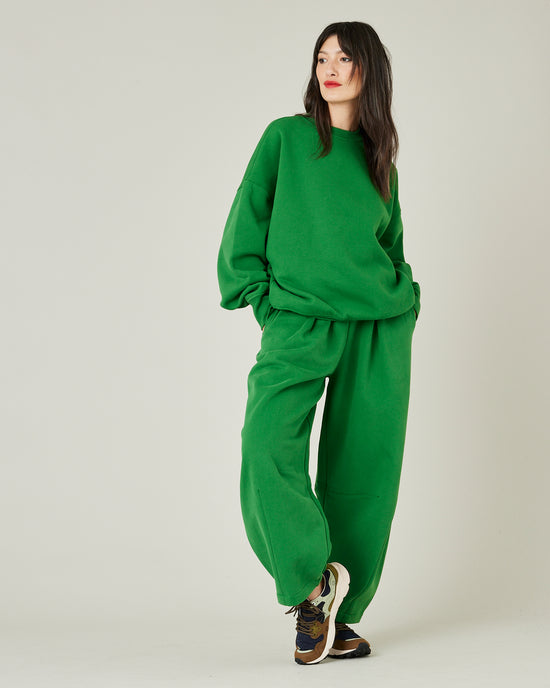 model wears juniper green daisy jersey trousers