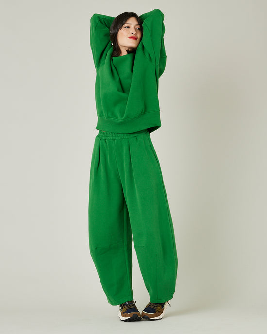 model wears juniper green daisy jersey trousers