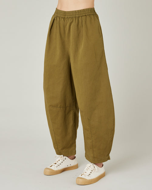 model wears Sicilian green daisy twill trousers left