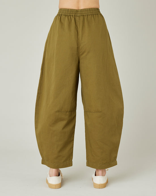 model wears Sicilian green daisy twill trousers back