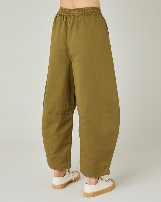 model wears Sicilian green daisy twill trousers right