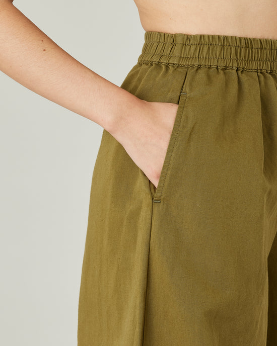 model wears Sicilian green daisy twill trousers 